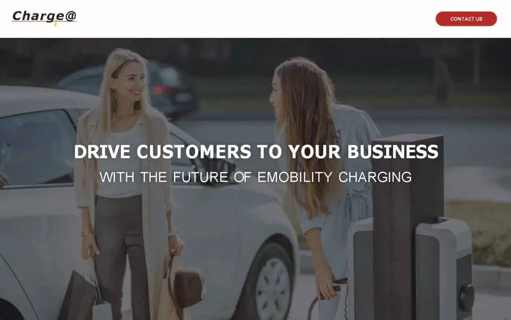 Two women interacting near an electric vehicle charging station, promoting emobility charging solutions for businesses.