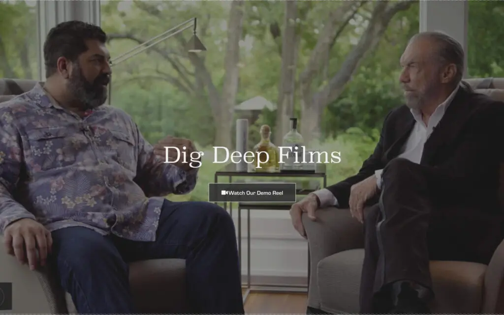 Two men engaged in a conversation while seated in a cozy indoor setting, surrounded by greenery. The image features the text "Dig Deep Films" prominently displayed, along with a button to "Watch Our Demo Reel."