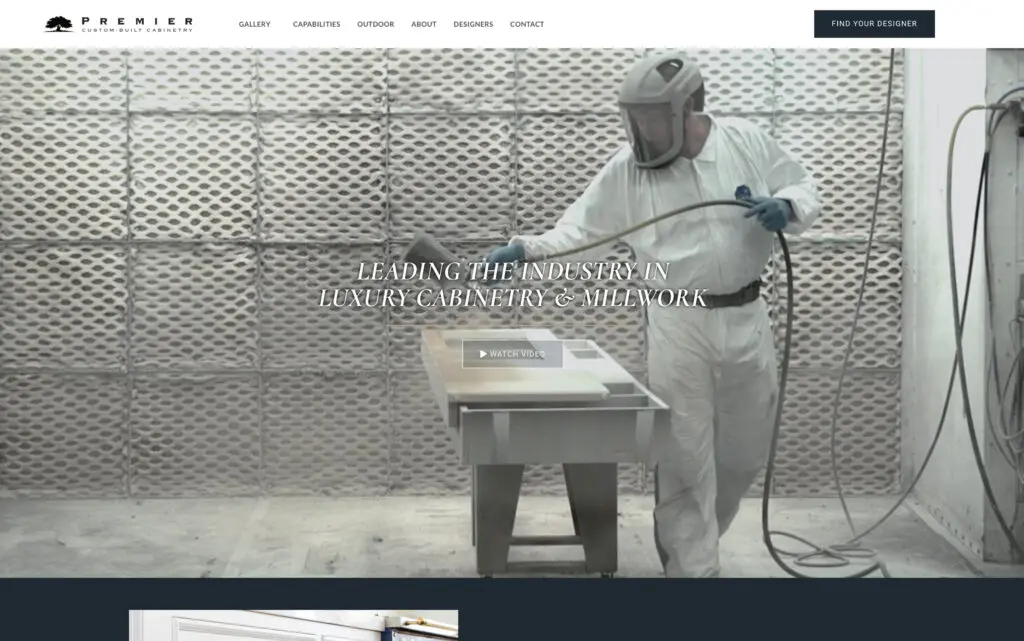 Worker in protective gear applying finish to luxury cabinetry in a professional spray booth, showcasing craftsmanship in millwork.