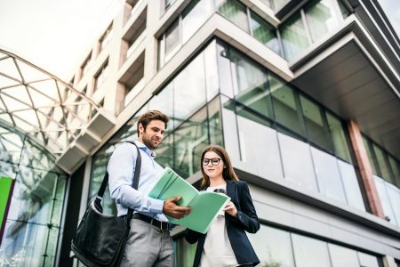 a-young-businessman-and-businesswoman-standing-in-LM5QHAS.jpg